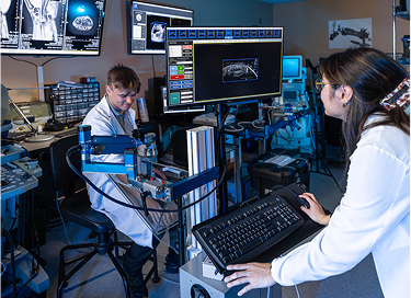 Researchers using imaging equipment in a lab